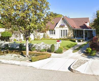 A house with a driveway and a tree in front of it

Description automatically generated with low confidence