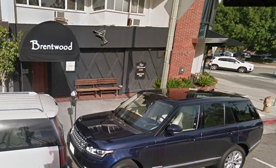 A blue car parked in front of a building

Description automatically generated with low confidence